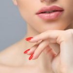 woman with orange nails