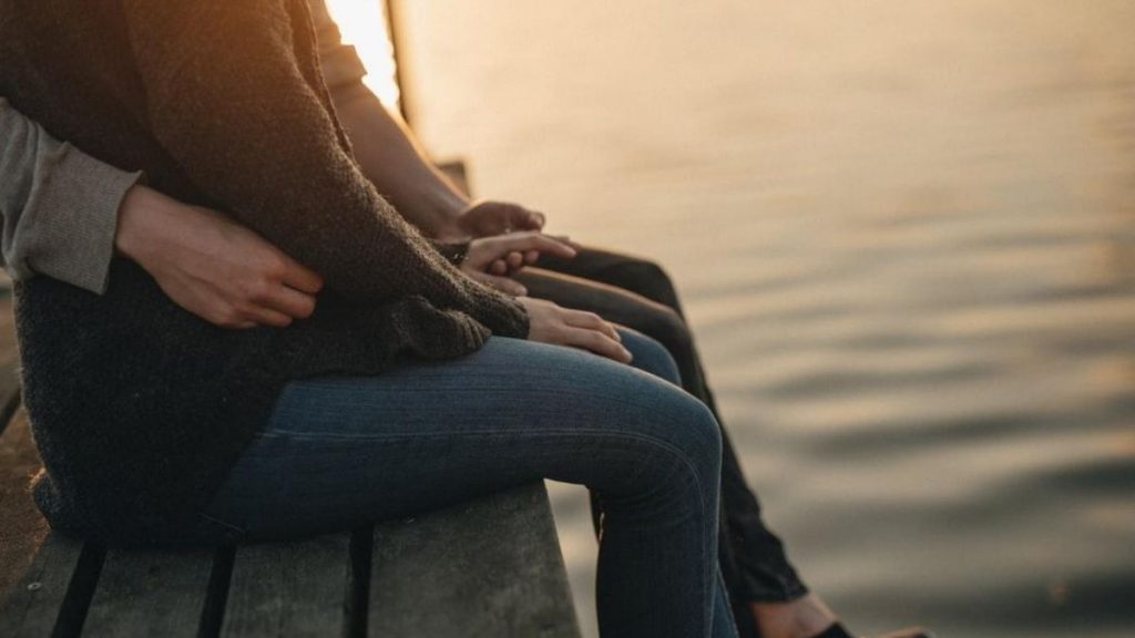 couple sitting by the sea