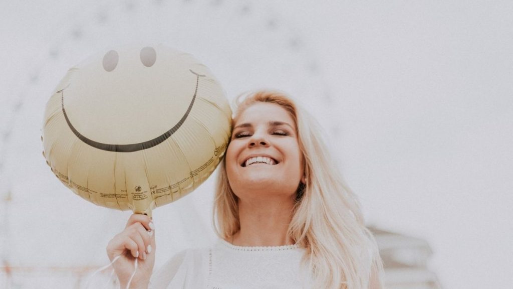 woman holding balloon