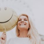 woman holding balloon