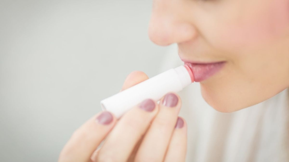 woman using lip balm