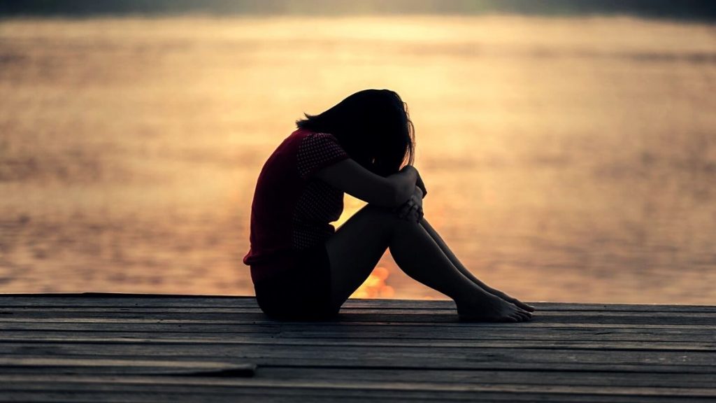 sad woman by the coast