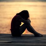 sad woman by the coast