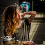 woman touching her neck