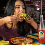 woman eating tacos