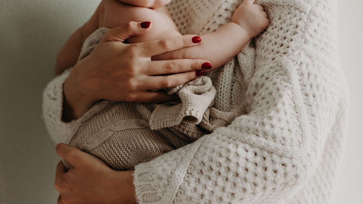 mom hugging baby